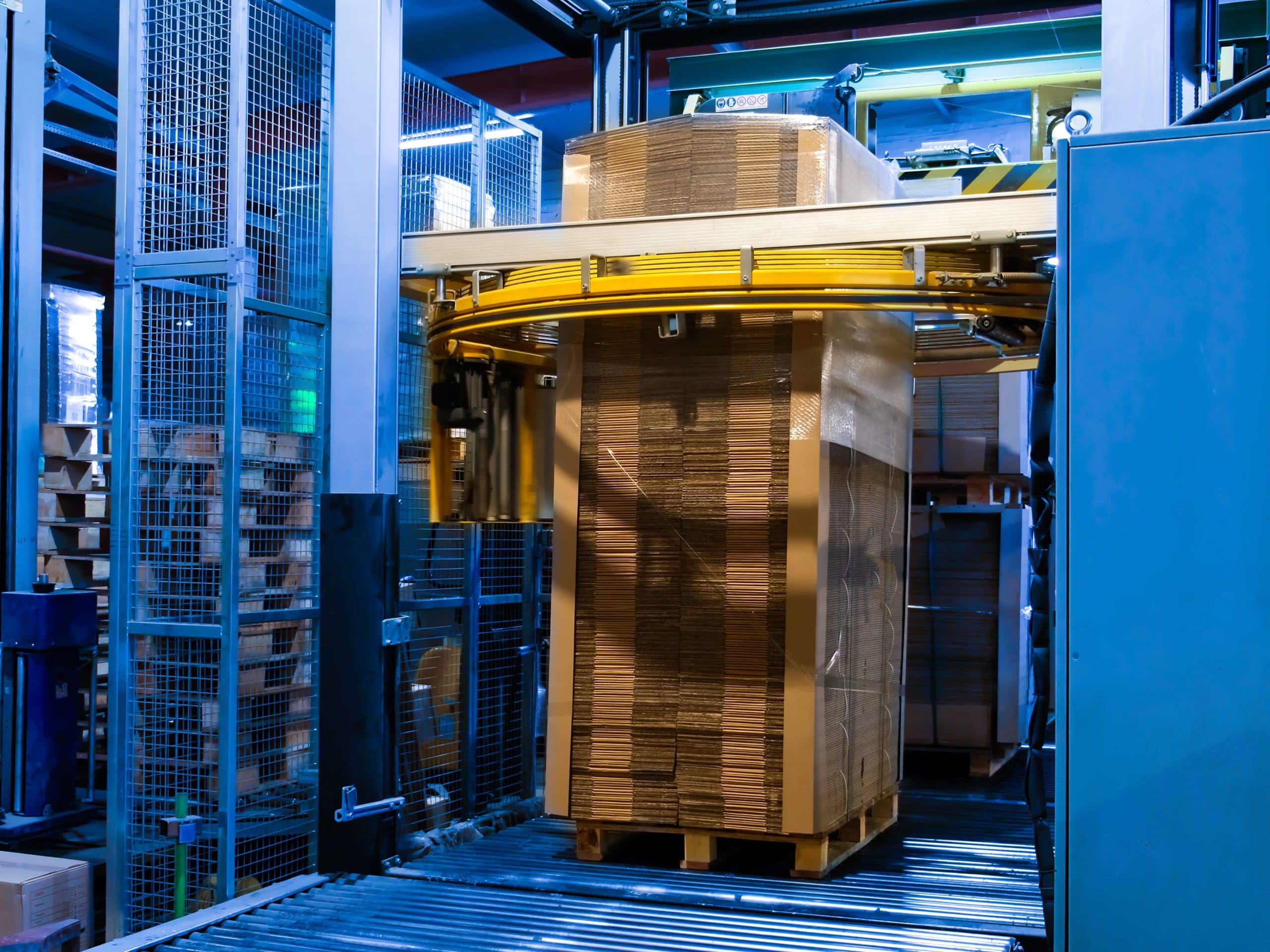 A pallet of cardboard in the process of being stretch-wrapped