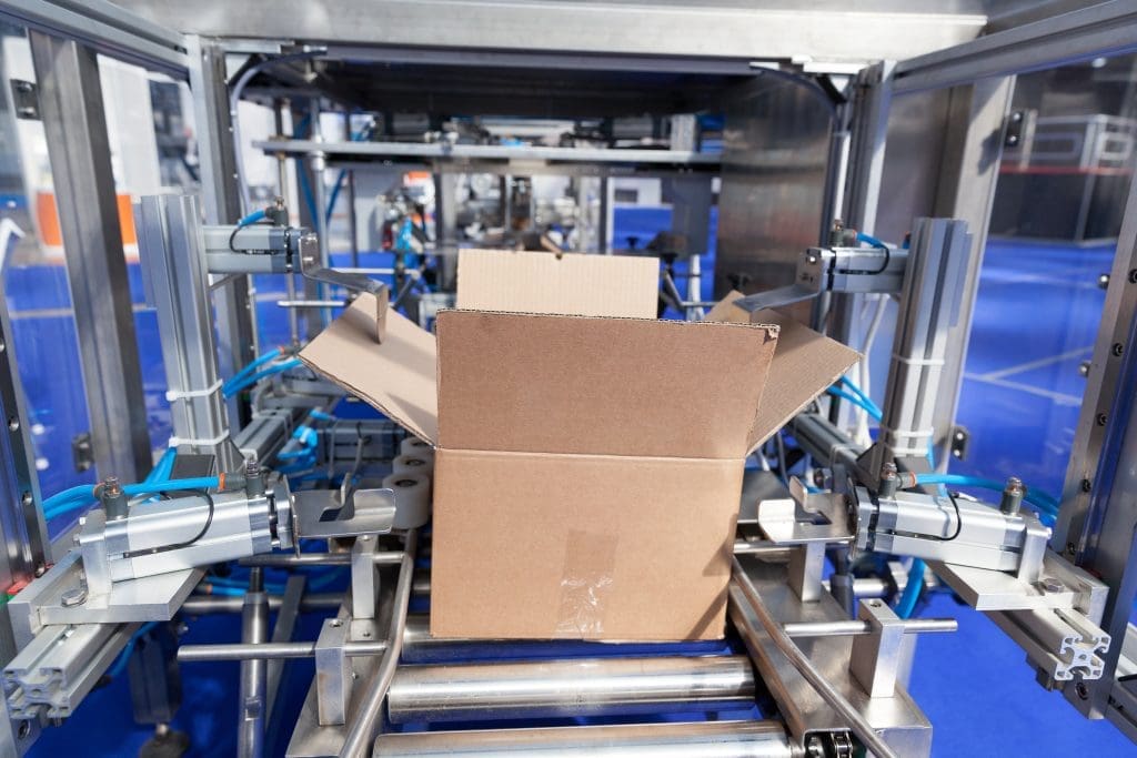 A cardboard box moving into a filling station.