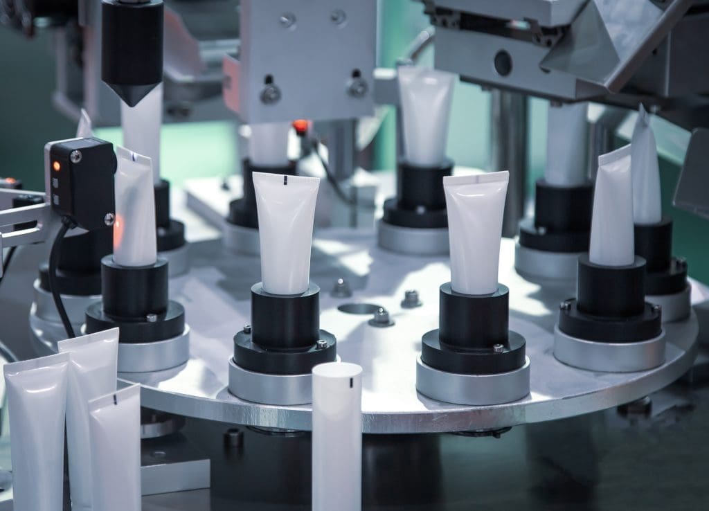White tubes in an automatic packaging line